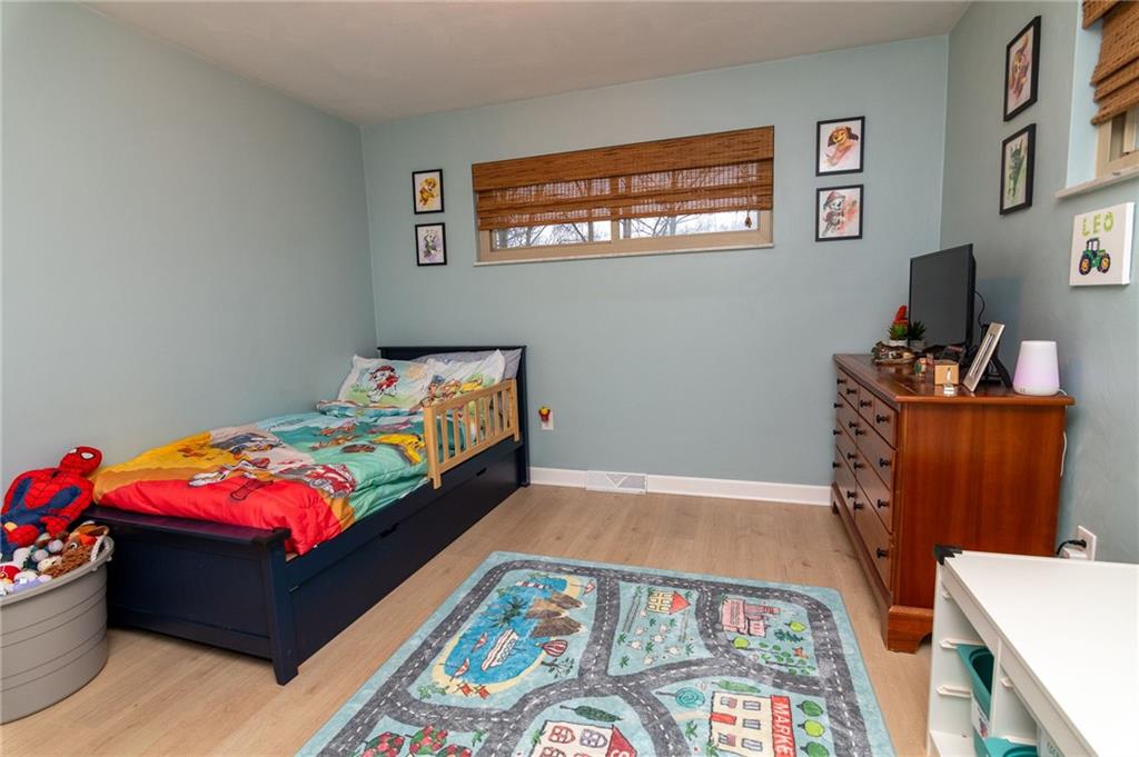 1005 Paintertown Road Irwin, PA 15642 - Photo 16 of 33 a bedroom with a bed and wooden floor