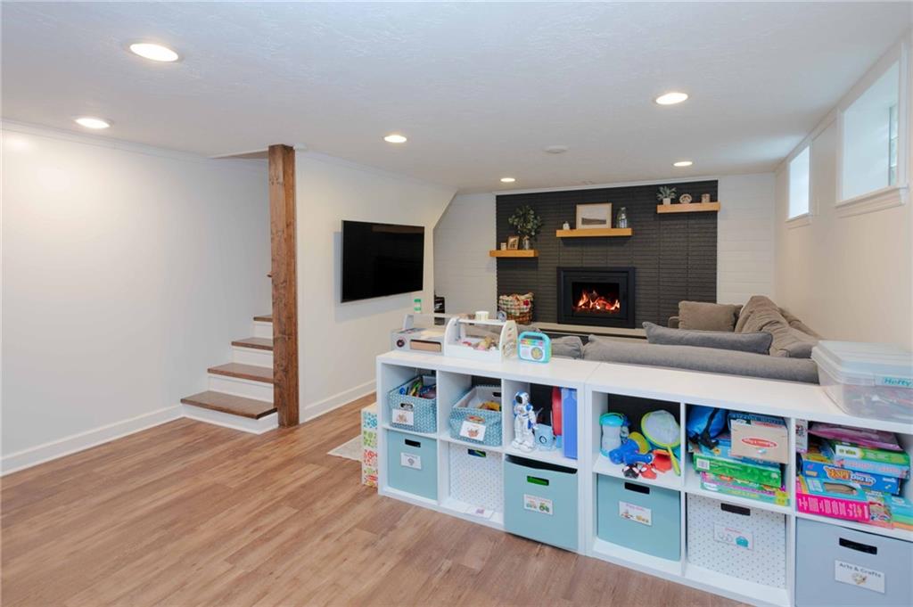 1005 Paintertown Road Irwin, PA 15642 - Photo 19 of 33 a room with furniture a flat screen tv and a book shelf