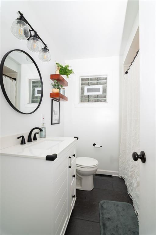 1005 Paintertown Road Irwin, PA 15642 - Photo 21 of 33 a bathroom with a sink a toilet and a mirror