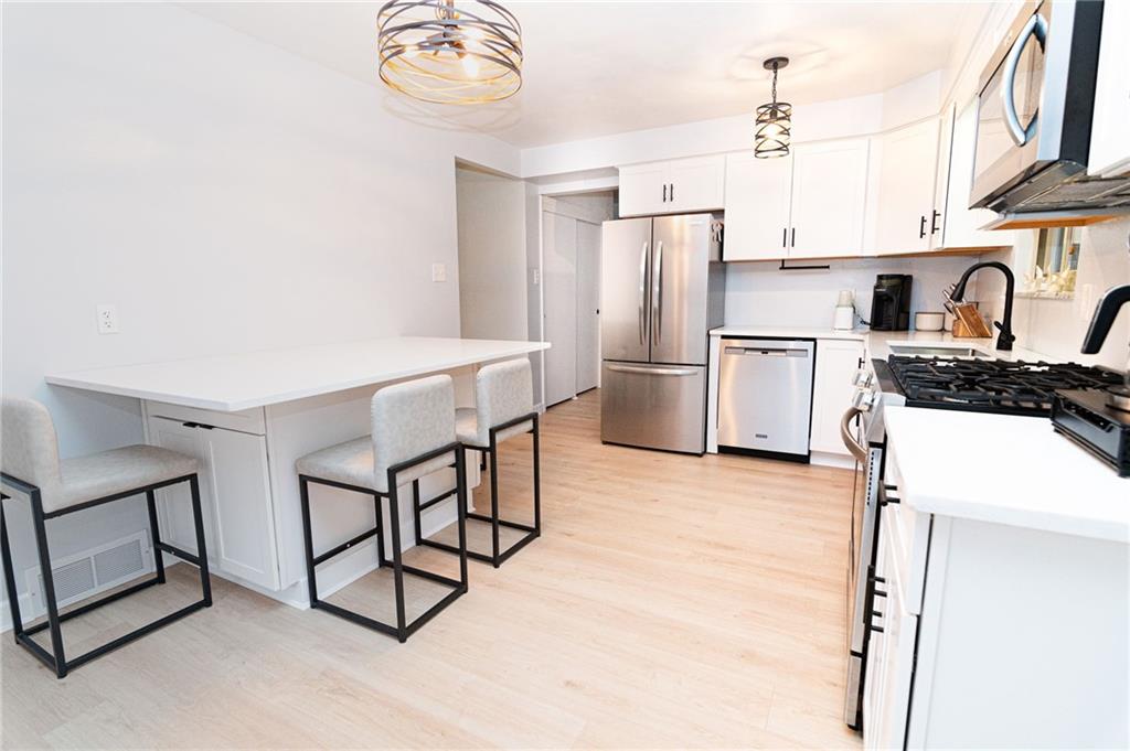 1005 Paintertown Road Irwin, PA 15642 - Photo 4 of 33 a kitchen with appliances cabinets and a counter top space
