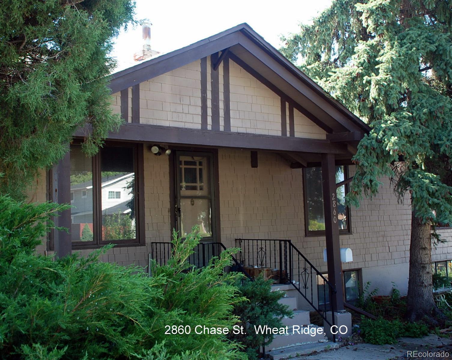 2860 Chase Street Wheat Ridge, CO 80214 - Photo 1 of 17 a front view of a house with garden