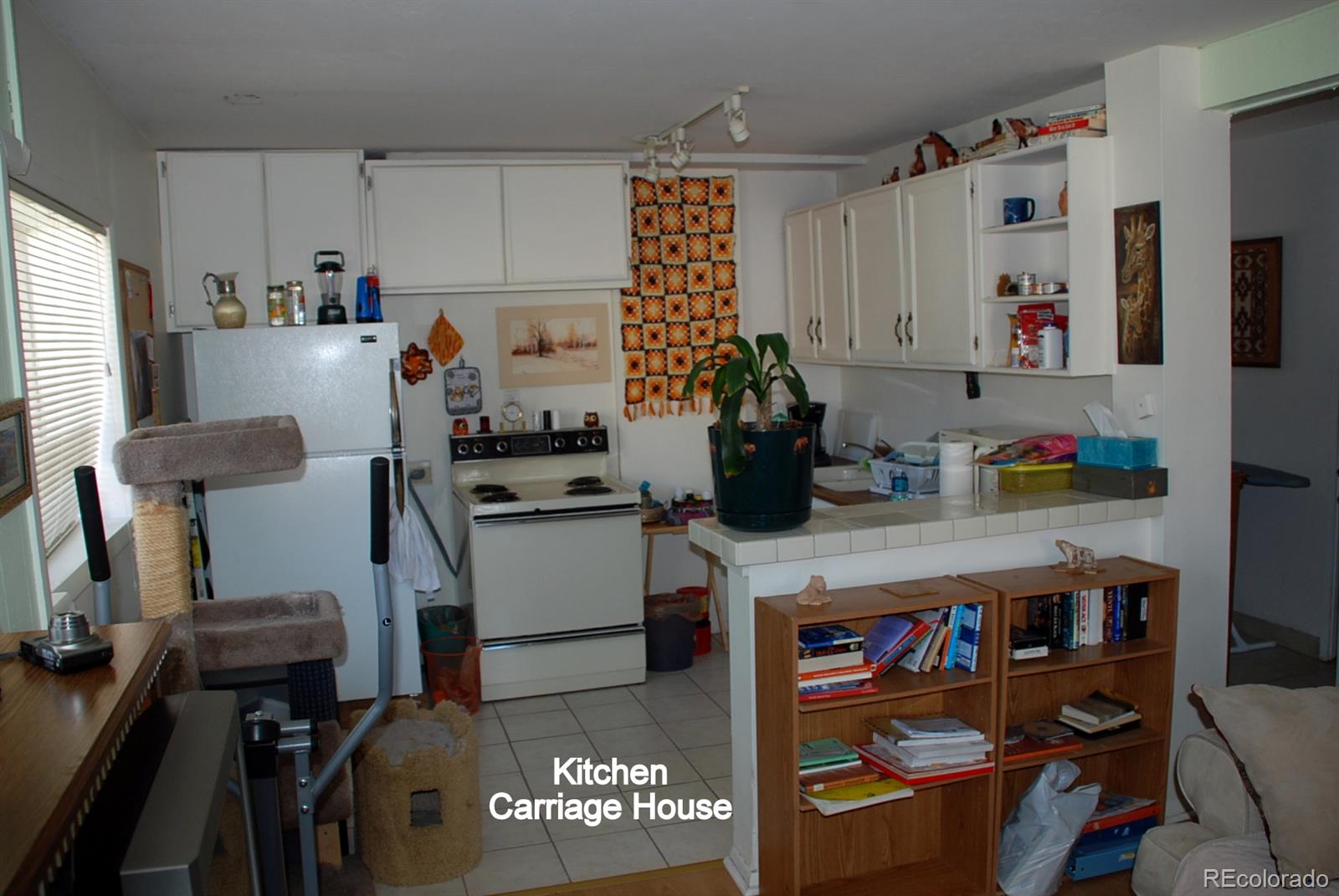 2860 Chase Street Wheat Ridge, CO 80214 - Photo 11 of 17 a kitchen with refrigerator and cabinets