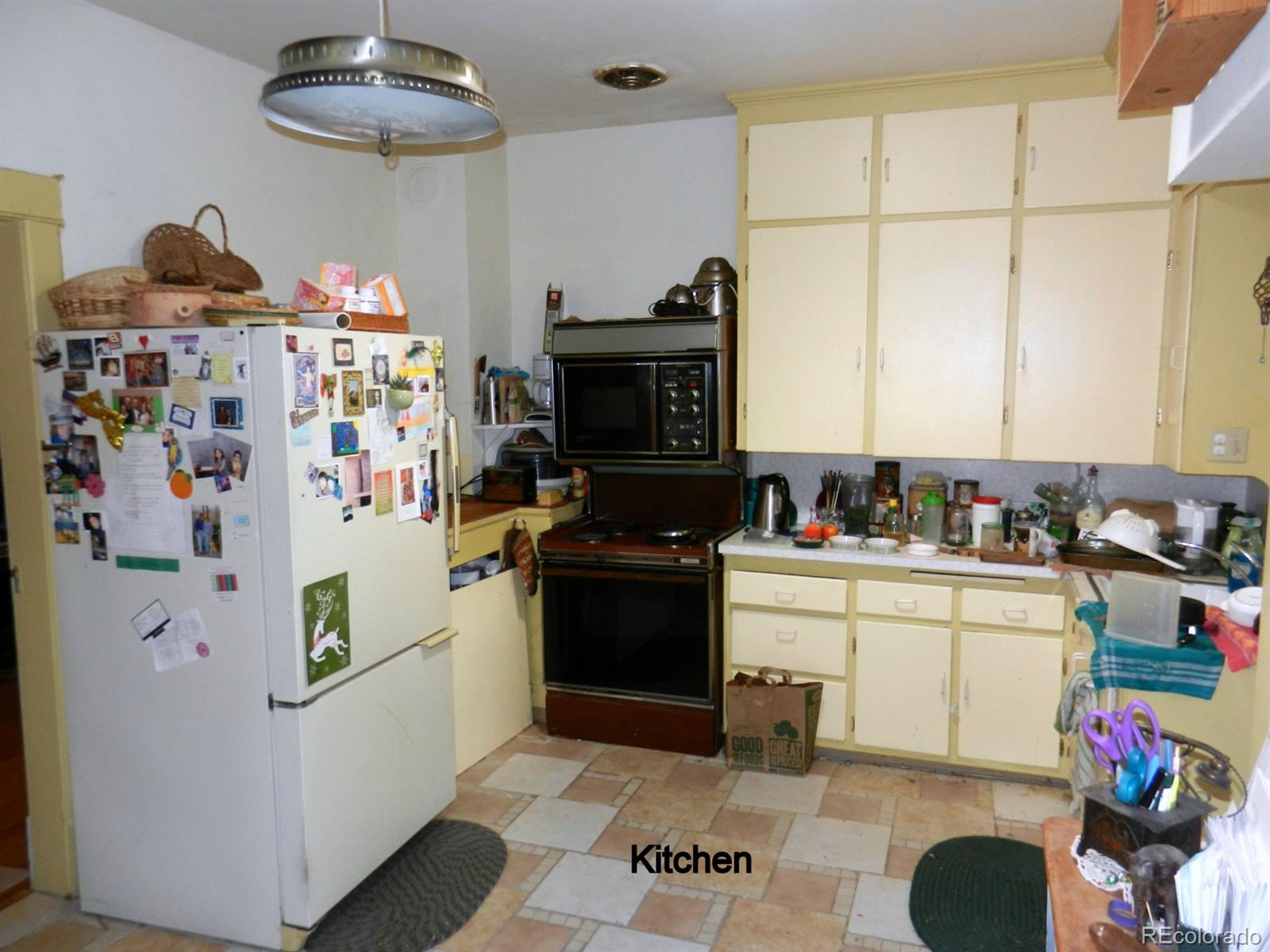 2860 Chase Street Wheat Ridge, CO 80214 - Photo 8 of 17 a kitchen with a refrigerator and a stove