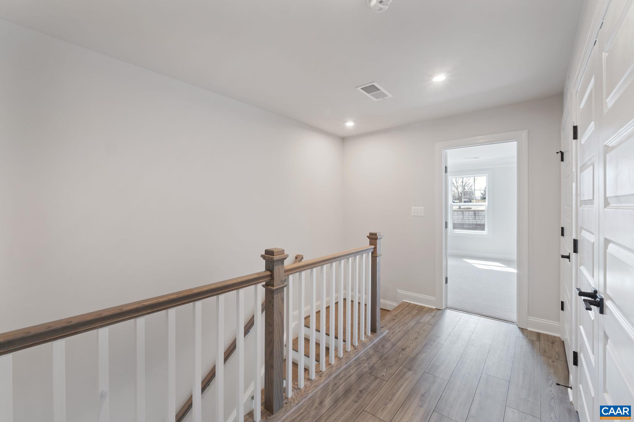 313 Ridgeline Drive Waynesboro, VA 22980 - Photo 21 of 34 a view of a hallway with wooden floor and staircase