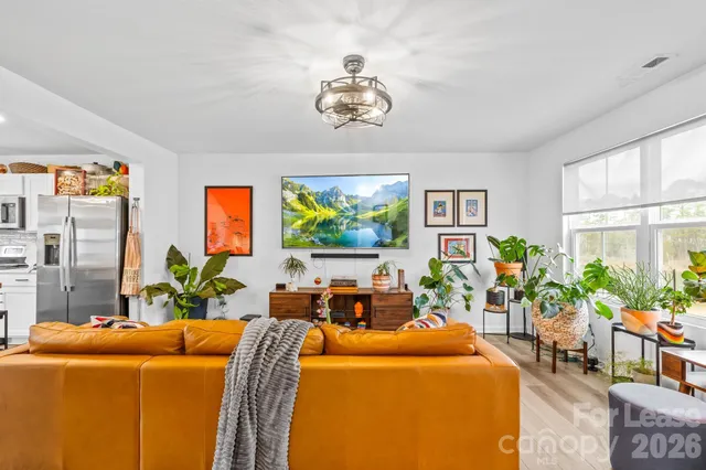 a living room with fireplace furniture and a flat screen tv