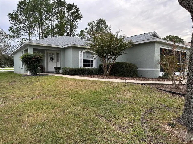 a front view of a house with yard and garage