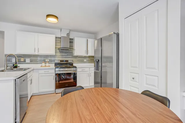 a kitchen with a stove sink and a refrigerator