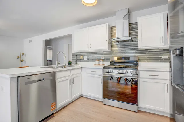 a kitchen with a stove cabinets and a sink