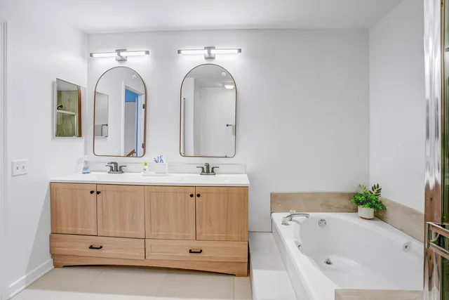 a bathroom with a double vanity sink and a bathtub