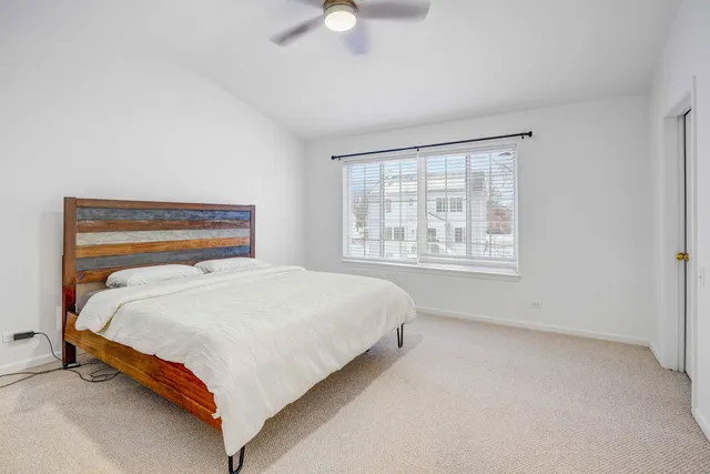 a bedroom with a bed lamp and window