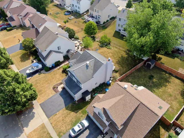 an aerial view of a house with a yard