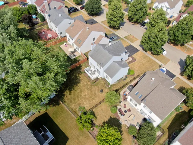 an aerial view of a house with a yard