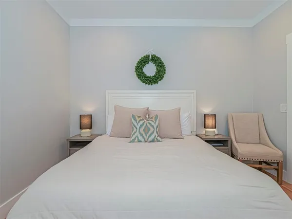 a bedroom with a bed and a lamp