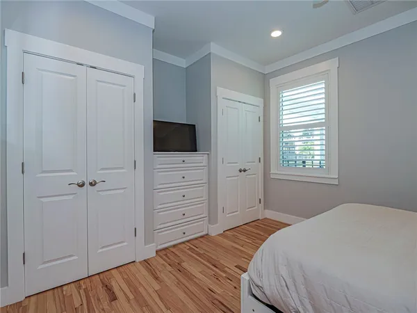 a bedroom with a bed and a flat tv screen