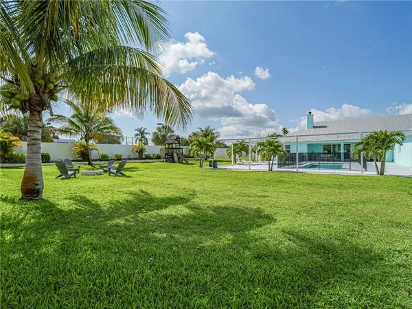 a view of a fountain in front of a house with a big yard