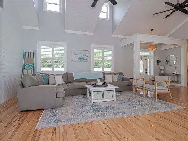 a living room with furniture and a wooden floor
