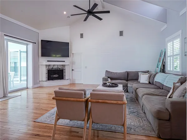 a living room with furniture a flat screen tv and a fireplace