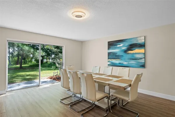 a view of a dining room with furniture wooden floor and front door