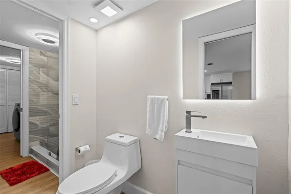 a bathroom with a toilet a sink and shower