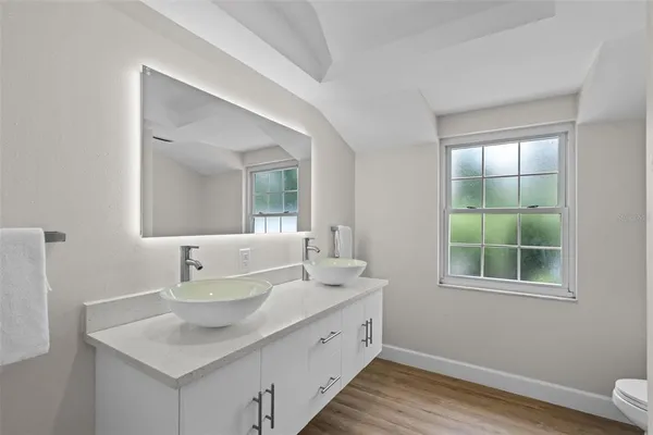 a spacious bathroom with a sink and a mirror