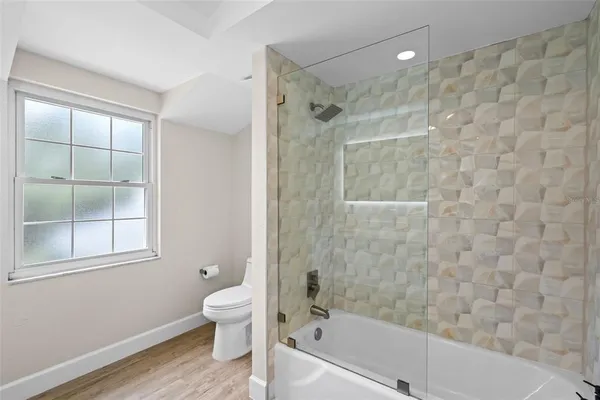 a bathroom with a bathtub and a shower