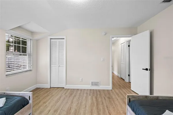 a view of room with window and wooden floor