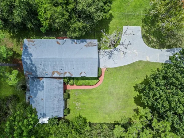 an aerial view of a house with swimming pool and outdoor space