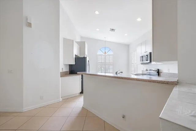 a kitchen with granite countertop a sink and a stove top oven