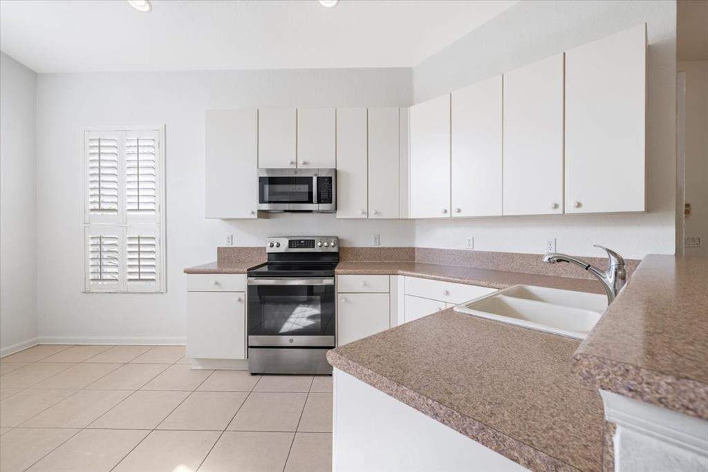 6300 Spring Lake Terrace Fort Pierce, FL 34951 - Photo 26 of 54 a kitchen with granite countertop a sink and a stove top oven