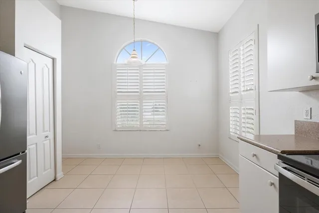 a kitchen with a refrigerator sink and cabinets