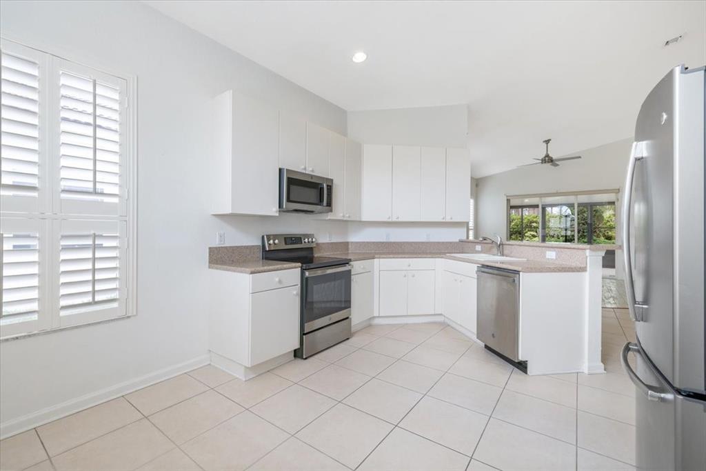 6300 Spring Lake Terrace Fort Pierce, FL 34951 - Photo 29 of 54 a kitchen with white cabinets and appliances