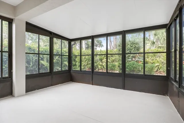 a view of an empty room with windows and a balcony