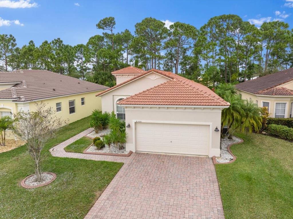 6300 Spring Lake Terrace Fort Pierce, FL 34951 - Photo 43 of 54 a front view of a house with a yard