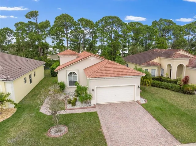 an aerial view of a house with a yard and lake view