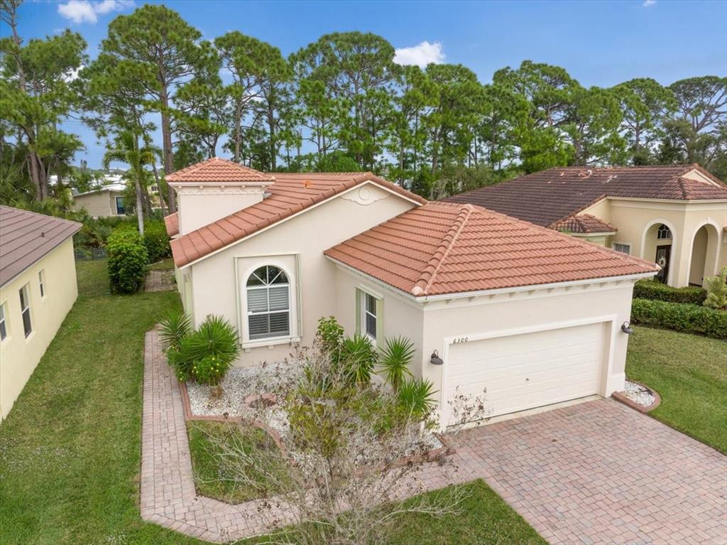 6300 Spring Lake Terrace Fort Pierce, FL 34951 - Photo 45 of 54 a aerial view of a house with a yard and large tree