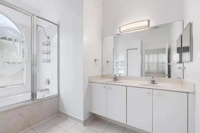 a bathroom with a double vanity sink mirror and