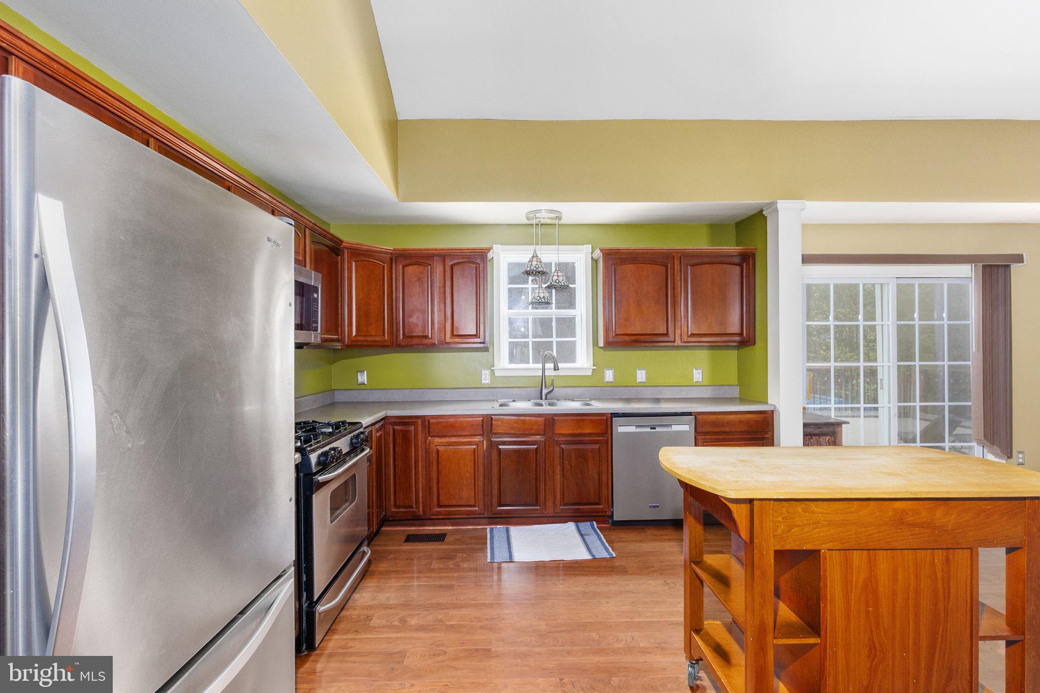 8314 Myrtle Lane King George, VA 22485 - Photo 13 of 40 a kitchen with stainless steel appliances granite countertop a sink and a refrigerator