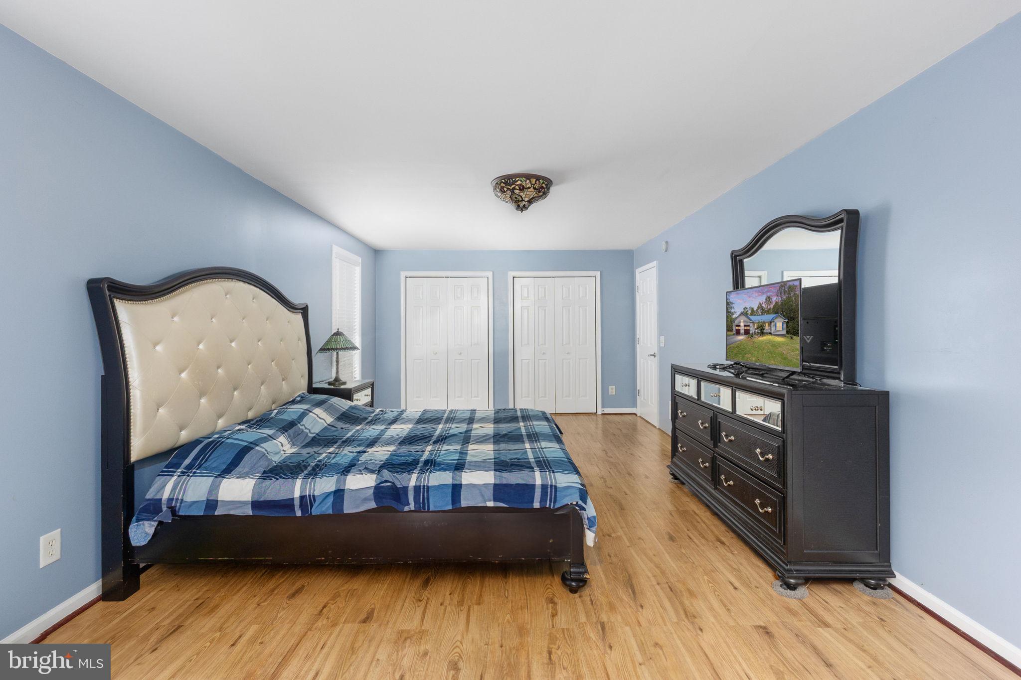 8314 Myrtle Lane King George, VA 22485 - Photo 17 of 40 a bedroom with a bed and wooden floor