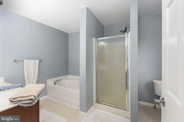 a white bath tub sitting next to a white toilet