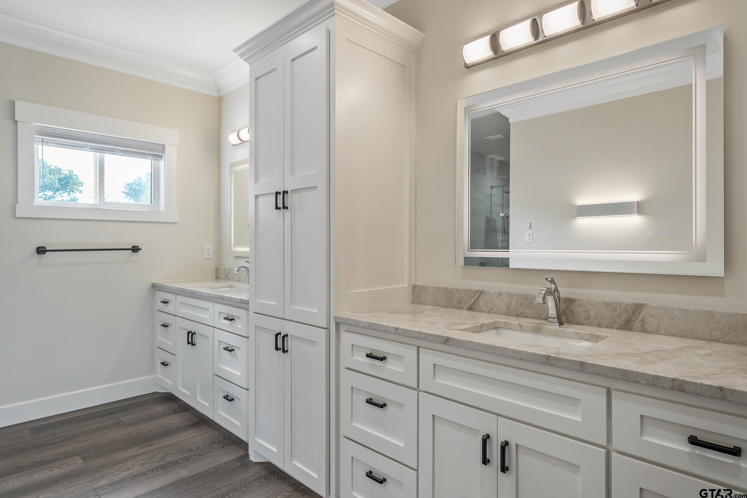 16919 Sawyer Way Lindale, TX 75771 - Photo 16 of 43 a bathroom with a double vanity sink and mirror with wooden floor