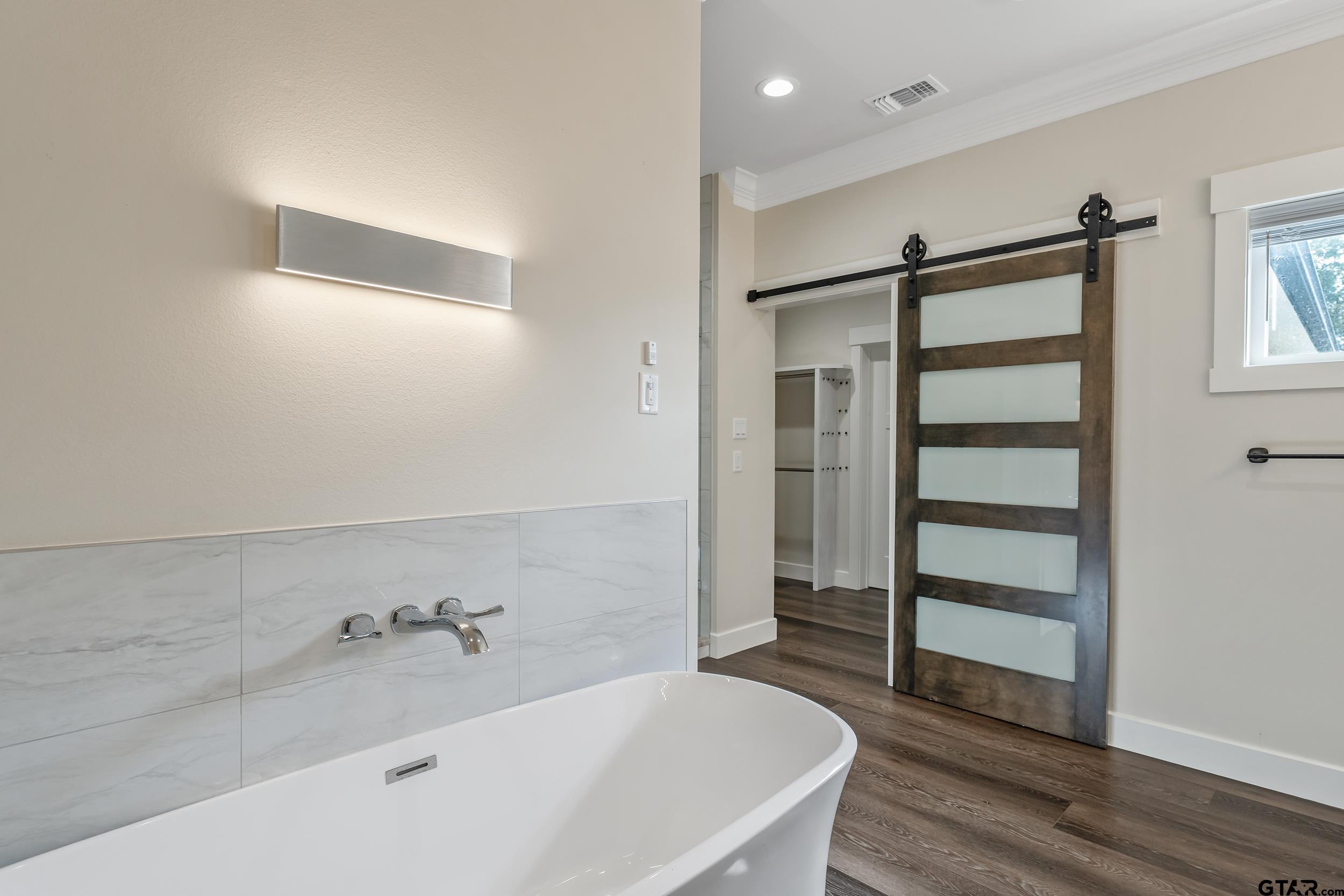 16919 Sawyer Way Lindale, TX 75771 - Photo 18 of 43 a bathroom with a bathtub and a shower