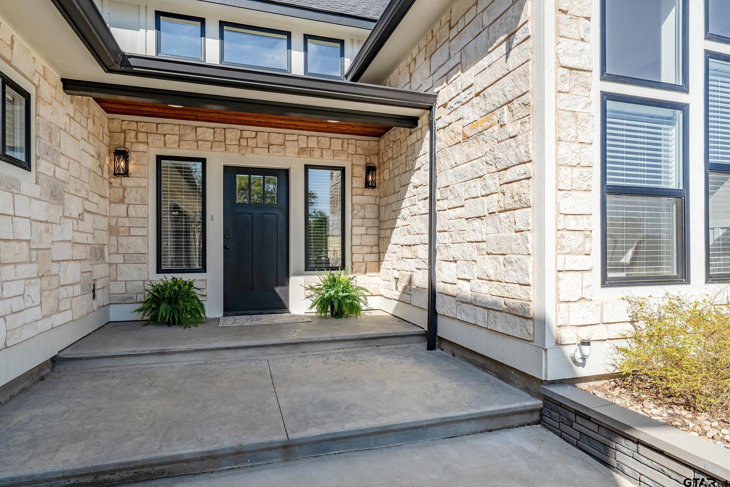 16919 Sawyer Way Lindale, TX 75771 - Photo 2 of 43 a view of a brick house with potted plants