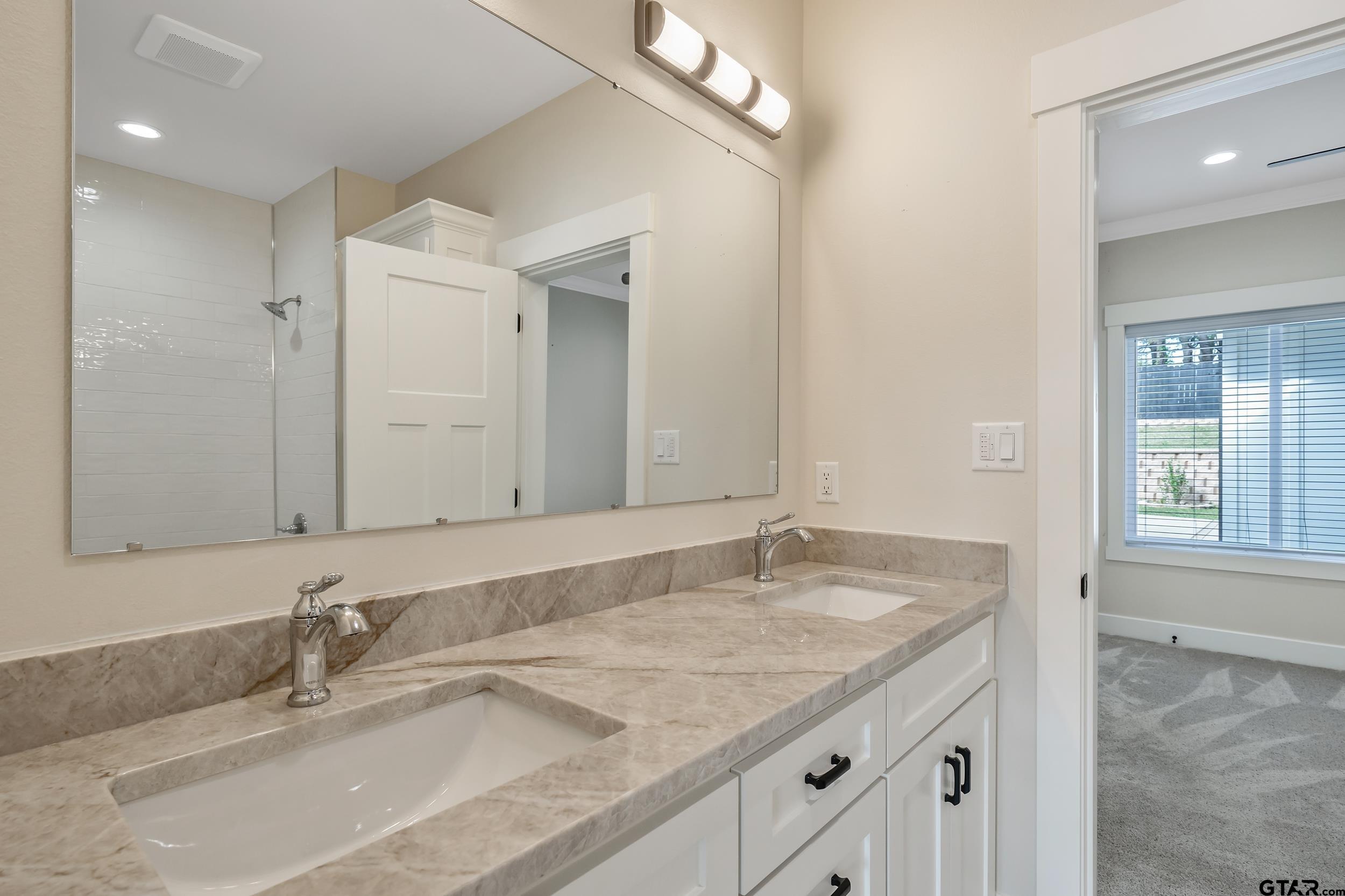 16919 Sawyer Way Lindale, TX 75771 - Photo 23 of 43 a bathroom with a granite countertop sink and a mirror