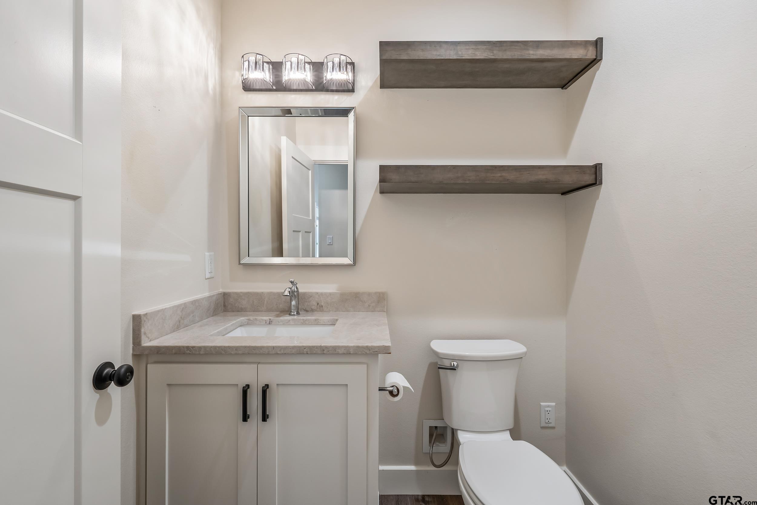 16919 Sawyer Way Lindale, TX 75771 - Photo 28 of 43 a bathroom with a sink and a toilet