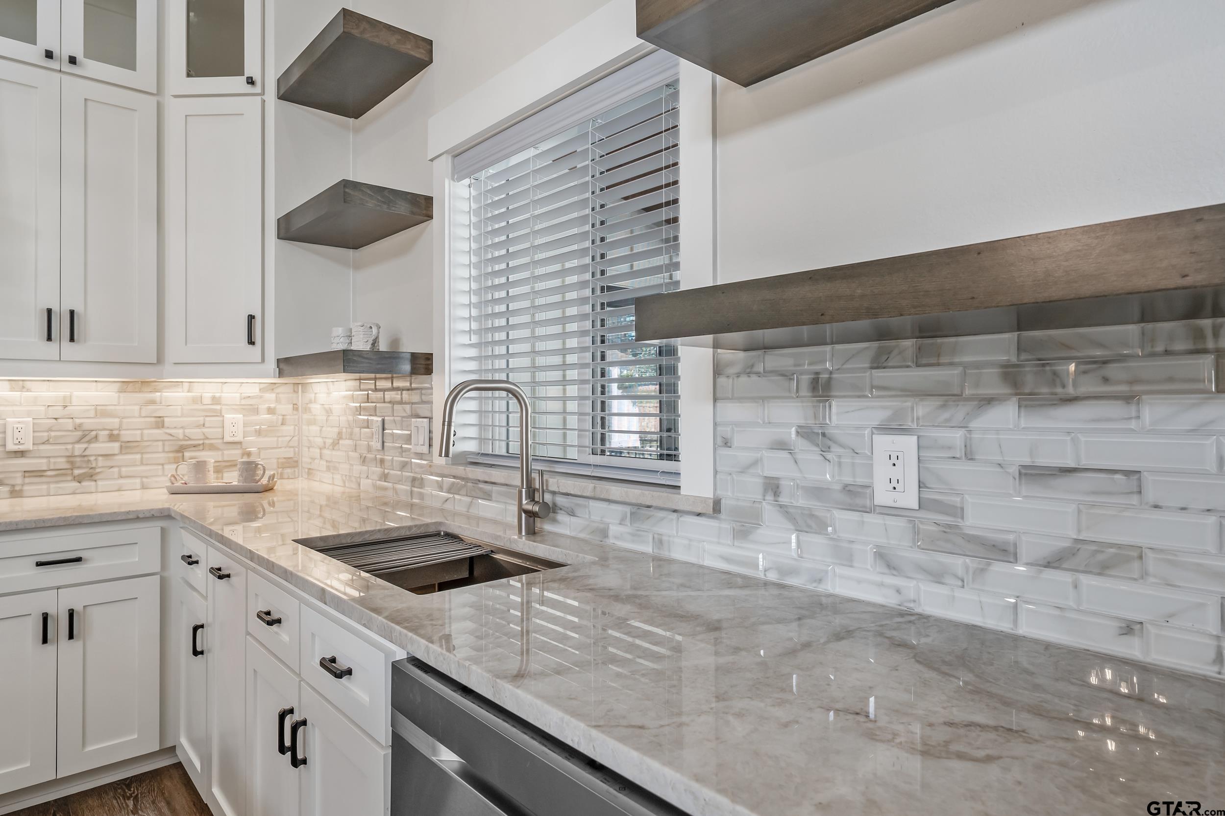 16919 Sawyer Way Lindale, TX 75771 - Photo 4 of 43 a kitchen with a sink and cabinets