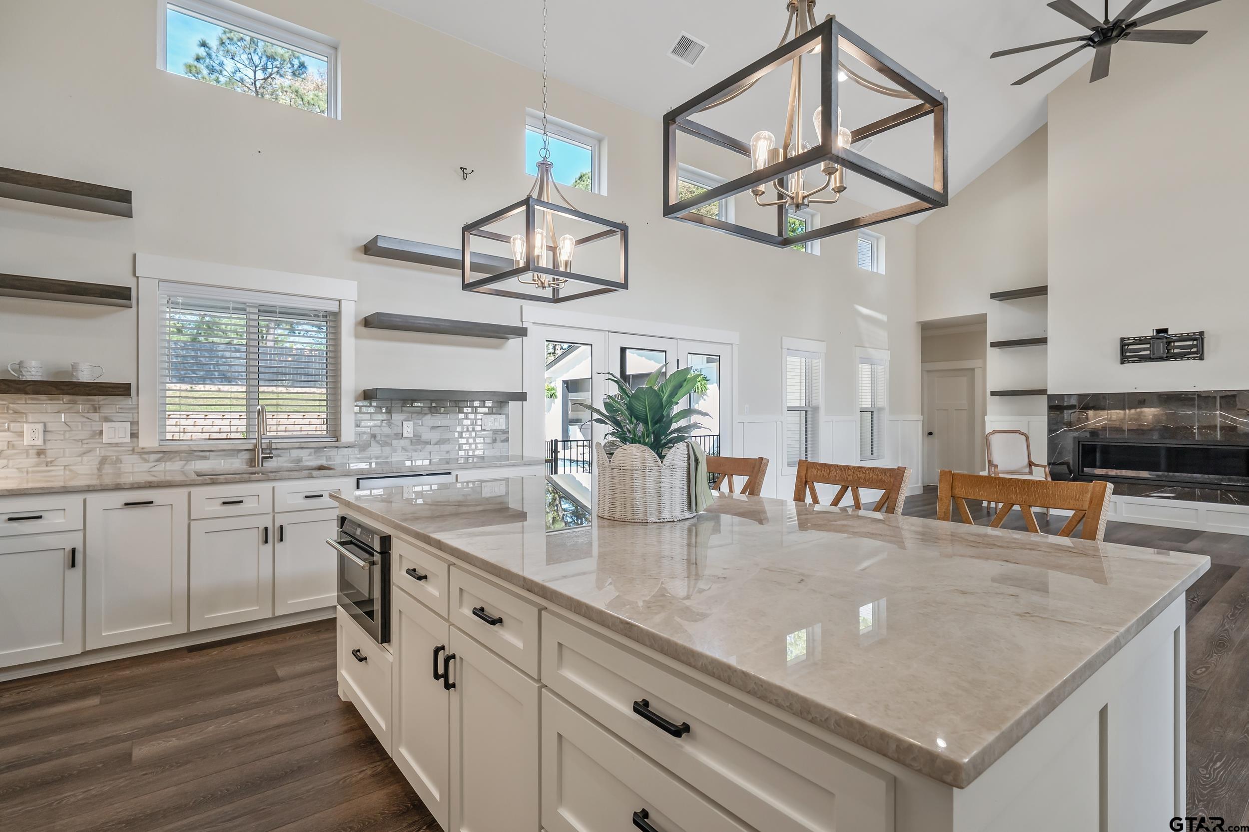 16919 Sawyer Way Lindale, TX 75771 - Photo 6 of 43 a kitchen with stainless steel appliances granite countertop a sink a stove and a wooden cabinets