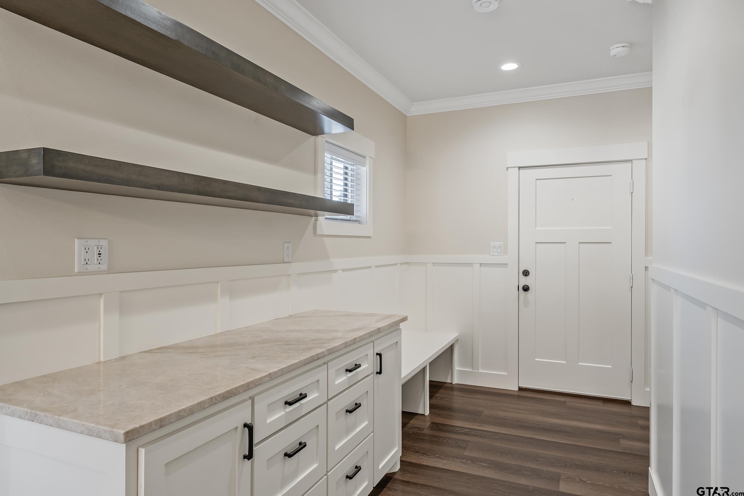 16919 Sawyer Way Lindale, TX 75771 - Photo 10 of 43 a kitchen with white cabinets and wooden floor