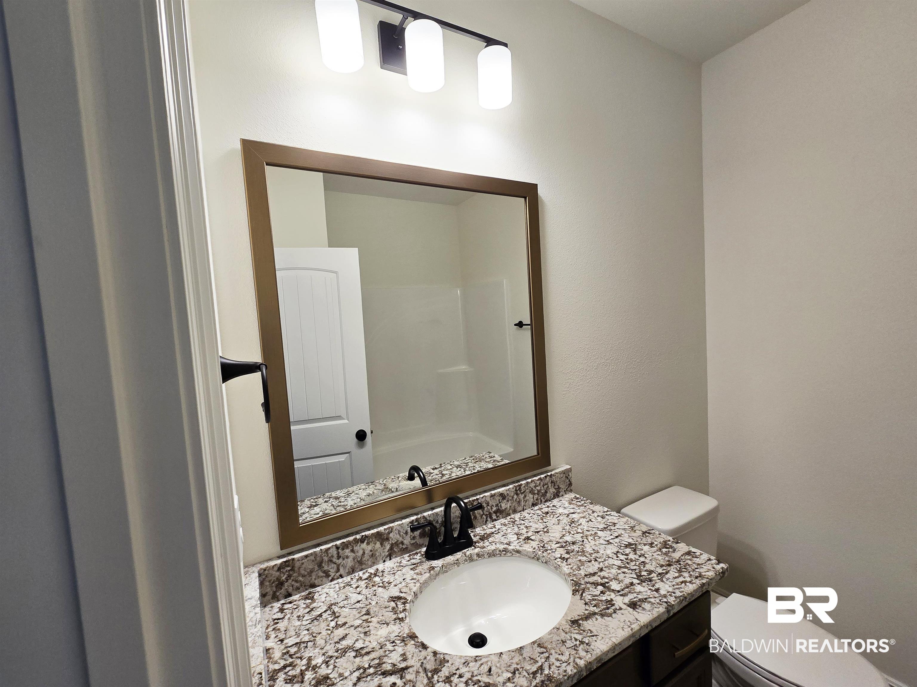 11178 Bonaventure Avenue Daphne, AL 36526 - Photo 16 of 20 Bathroom featuring vanity and a shower