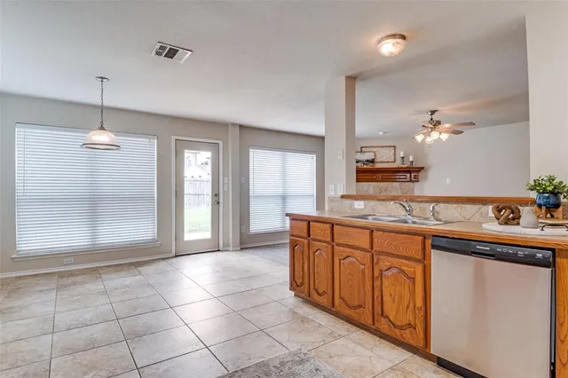 a large kitchen with granite countertop a sink and cabinets