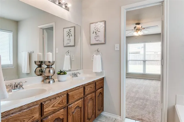 a bathroom with a double vanity sink and a mirror